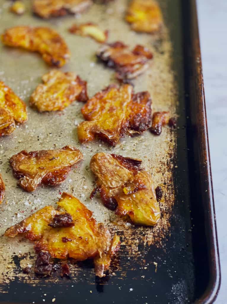 Crispy Smashed Potatoes after being done cooking in the oven on a baking sheet.