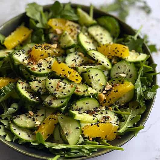 Cucumber and Orange Salad in a black bowl.