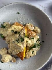 Pan Fried Polenta with Creamy Mushroom Sauce in a white bowl