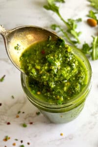Arugula Chimichurri Sauce in jar with spoon