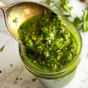 Arugula Chimichurri Sauce in jar with spoon