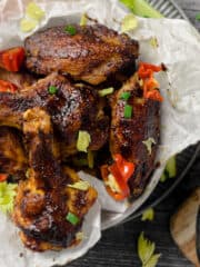 Chicken wings on a plate with a wood background
