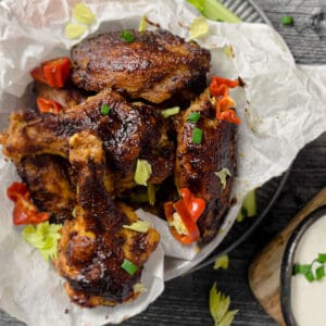 Chicken wings on a plate with a wood background