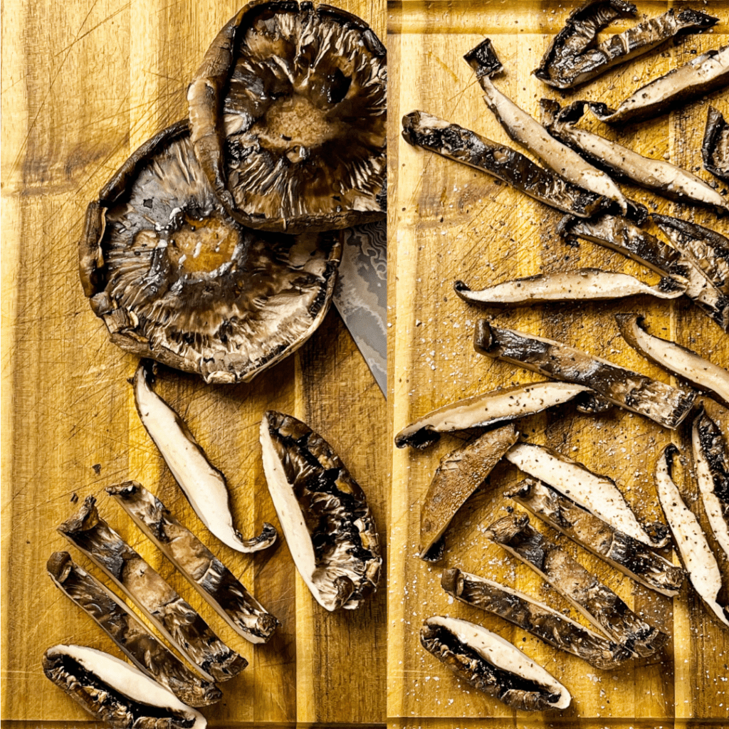 Cooked portobello mushrooms getting sliced into strips on a cutting board