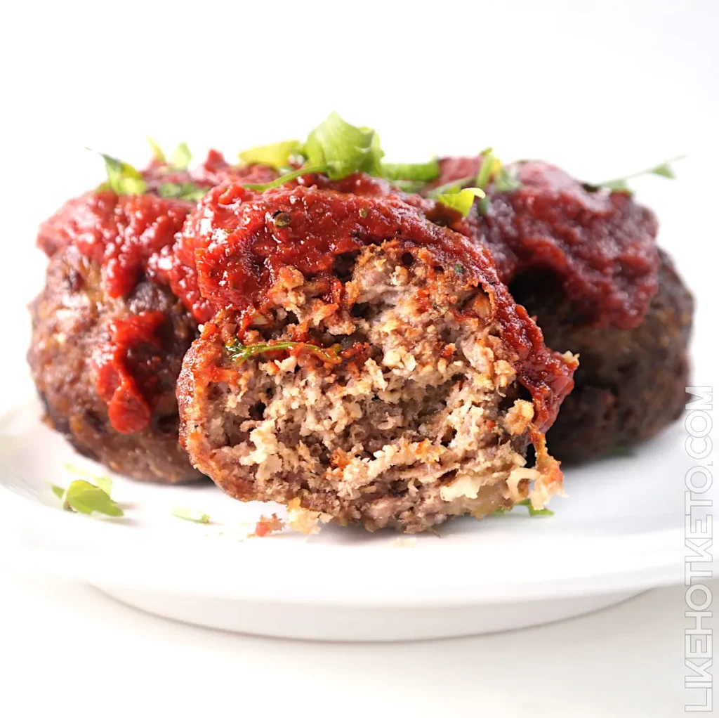 Close up of meatballs topped with tomato sauce