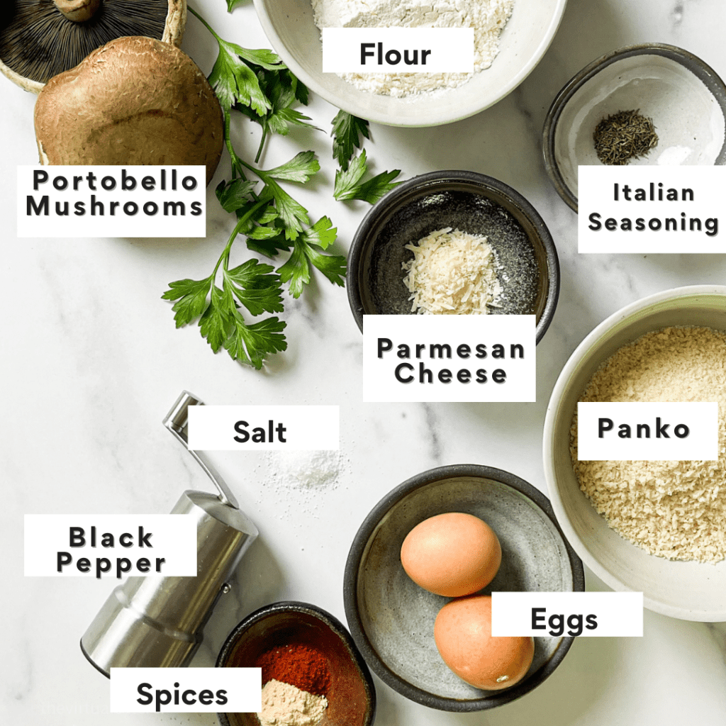 Ingredients needed to make portobello mushroom fries on a white marble background