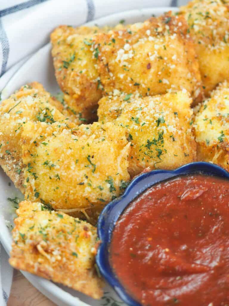 https://thevirtualcaterer.com/wp-content/uploads/2022/10/fried-ravioli-on-white-platter-with-marinara-sauce-1152x1536-1-768x1024.jpg