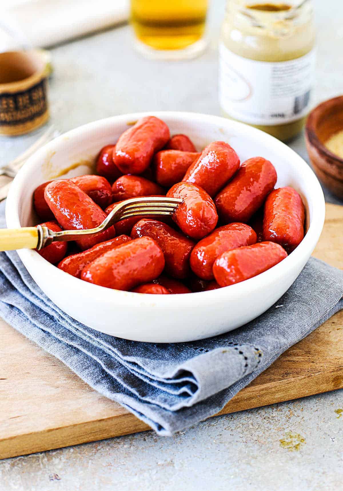 Bowl of cocktail sausage with fork.