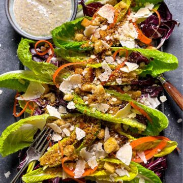 Romaine lettuce with carrots, croutons, breadcrumbs and parmesan cheese. Served on a platter with caesar dressing.