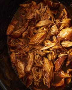 Up close shot of slow cooker bbq chicken after being shredded.