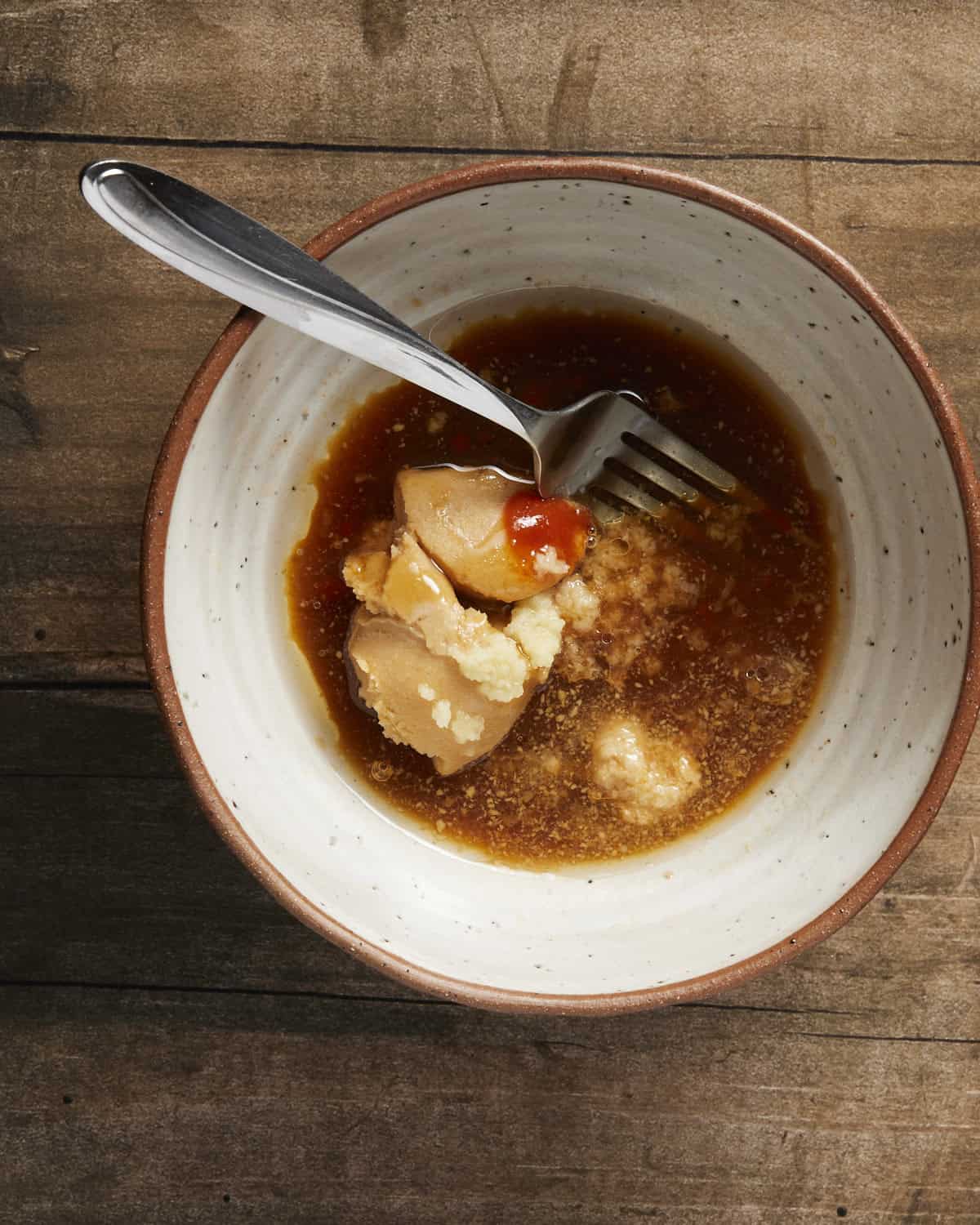 Ingredients needed to make the honey miso marinade in a bowl ready to be mixed. 