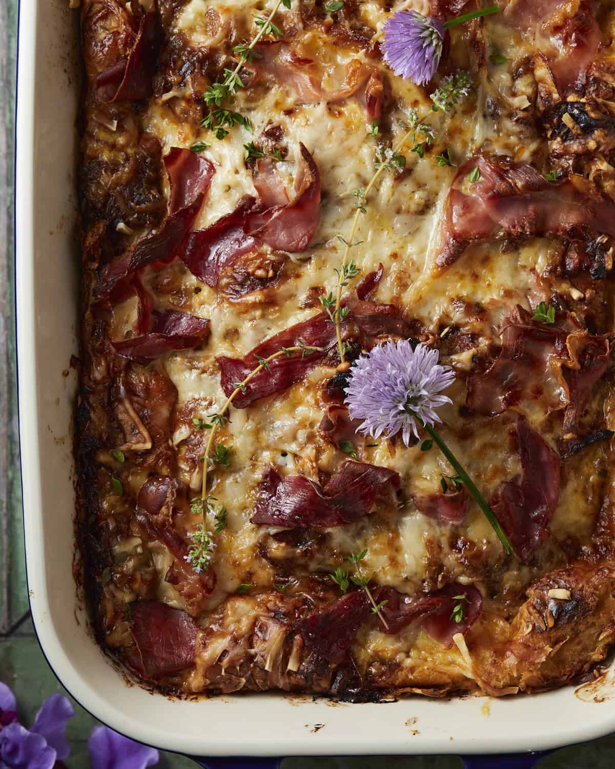 French onion croissant bake with thyme and onion flowes.