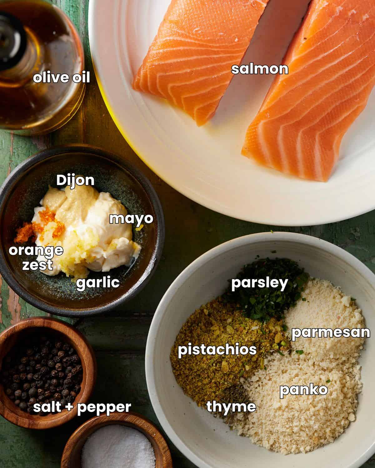 Ingredients needed to make pistachio crusted salmon on a green rustic background. 