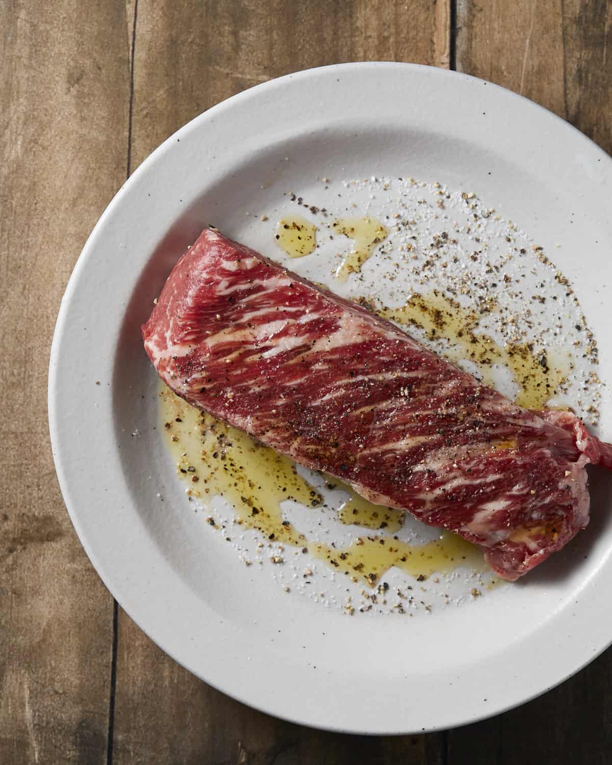 steak seasoned with salt and pepper for steak salad.