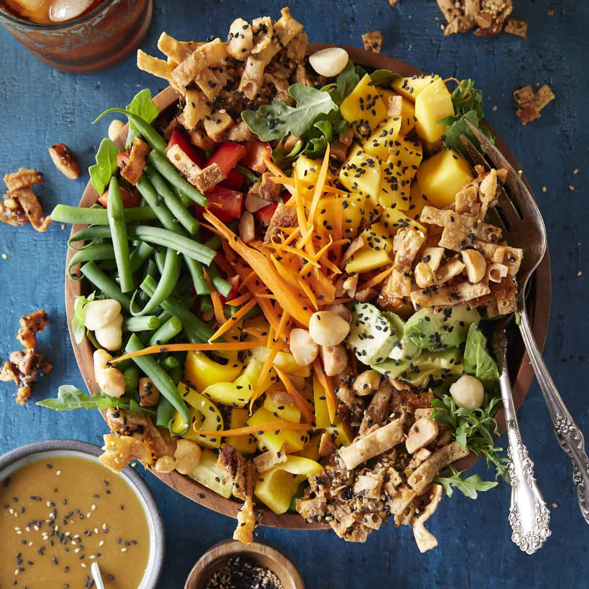 A cheesecake factory luau salad made easy for the home cook on a blue background.