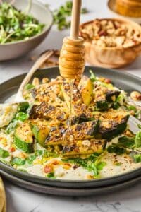 Charred zucchini salad with honey drizzle.