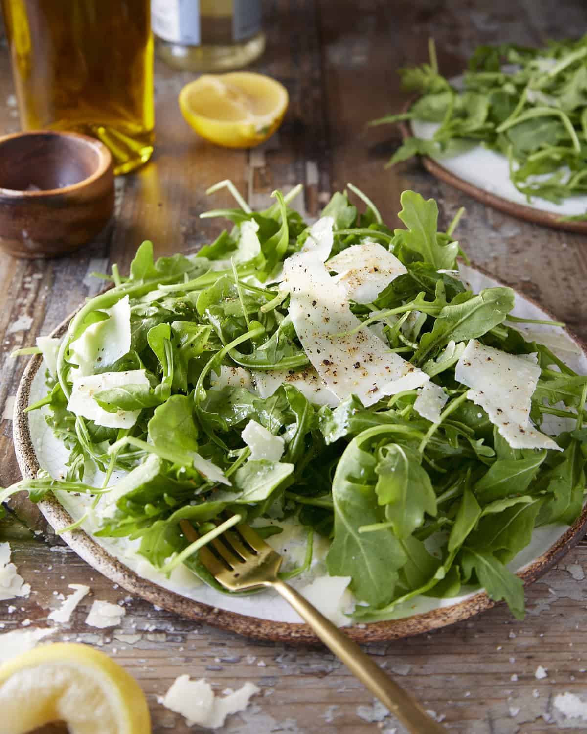 A simple salad with arugula, parmesan, lemon and olive oil.