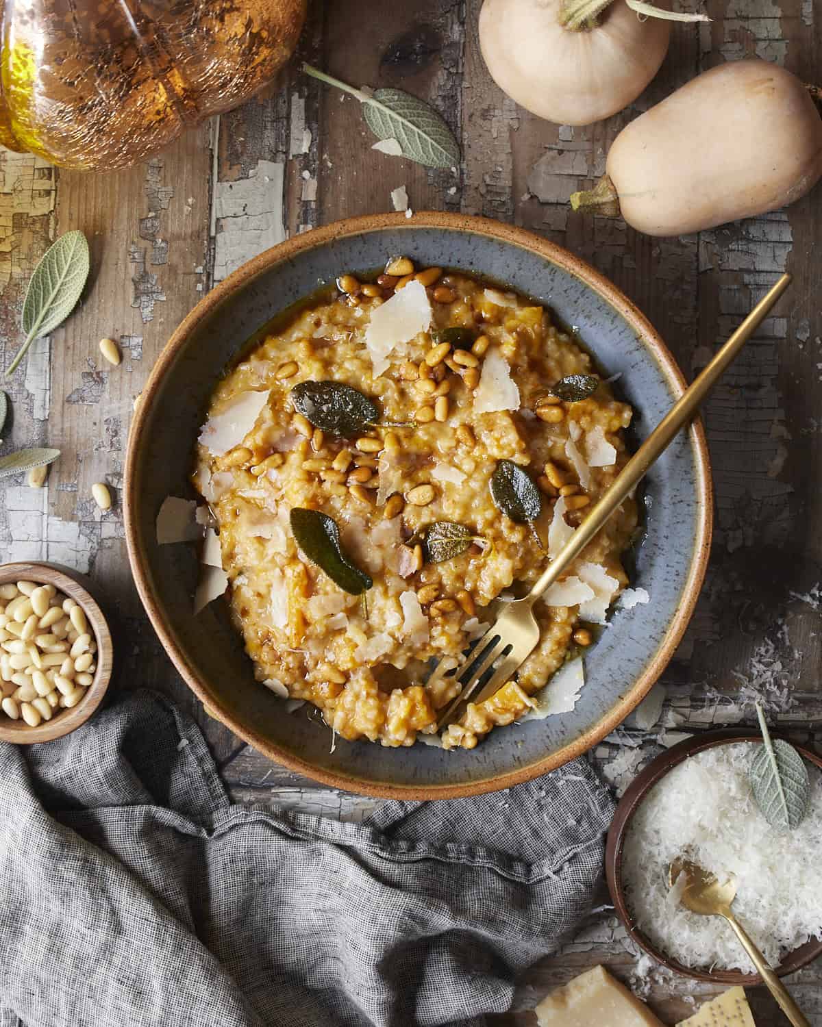 Butternut squash risotto with sage, brown butter and pine nuts in a bowl. 