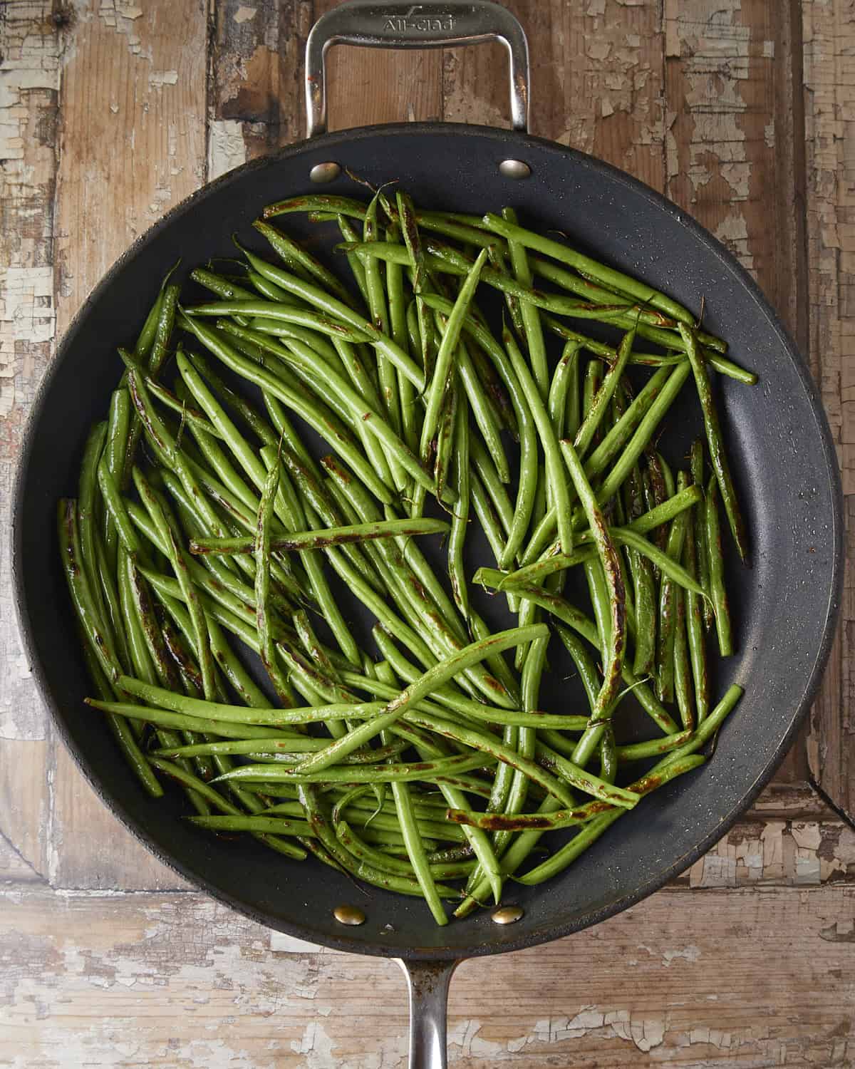 Cooking green beans in a skillet.