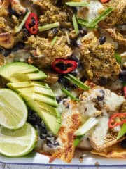 Sheet pan nachos with a pork chile verde sauce.